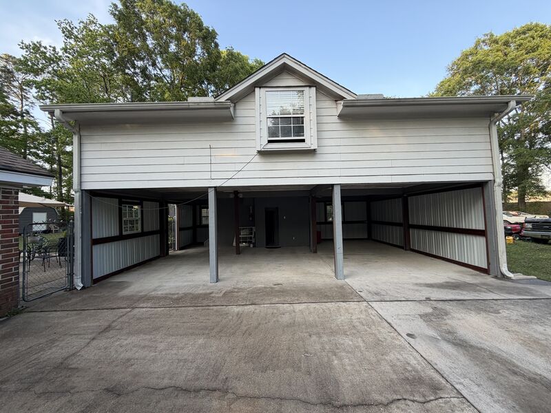 Finished front elevation with the carport bays framed and enclosed