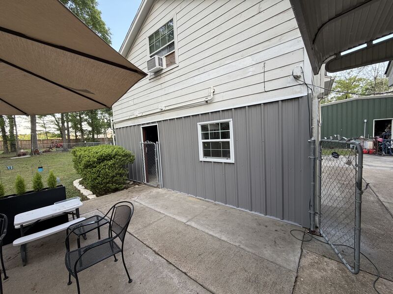 Enclosed side wall with a window set into the new metal siding