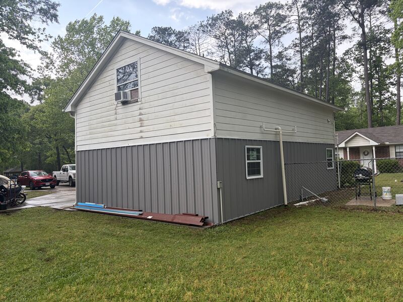 Metal siding installed across the gable end of the carport enclosure