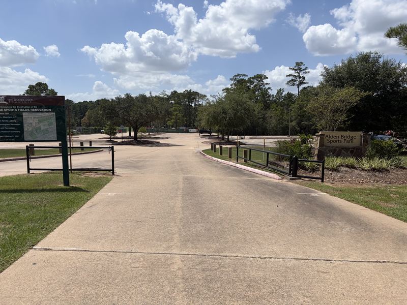 Steel entrance gates and guardrails installed at a commercial park entrance in The Woodlands