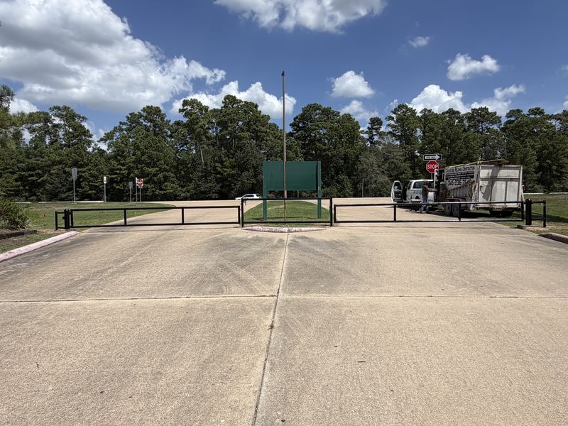 New steel barrier gates across the entrance drive at Alden Bridge Sports Park in The Woodlands