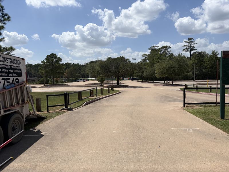 CrossSteel mobile welding trailer on-site during a steel guardrail installation at a Woodlands park