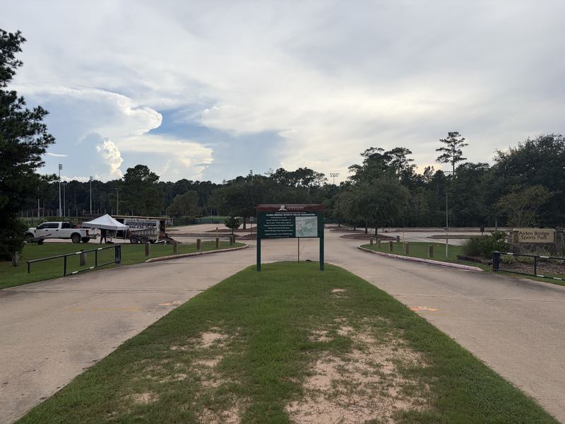 Steel barrier gates installed on both sides of a park entrance drive