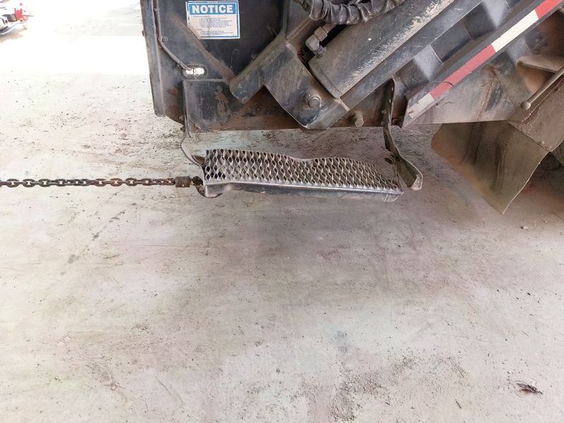 Bent and crushed diamond-plate truck step before repair